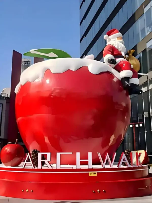 Custom fiberglass sculpture manufacturer, giant apple with Santa Claus fiberglass sculpture for outdoor commercial display