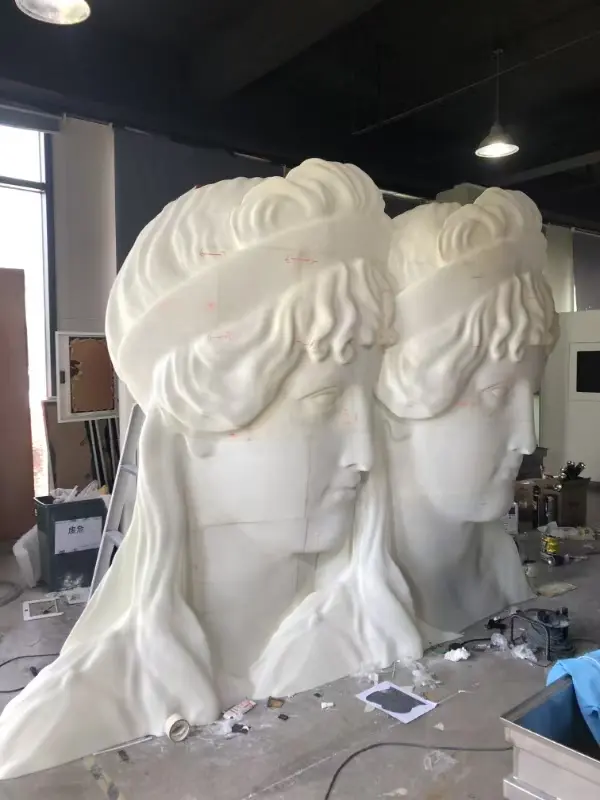 Large fiberglass bust sculpture in FRP workshop before finishing
