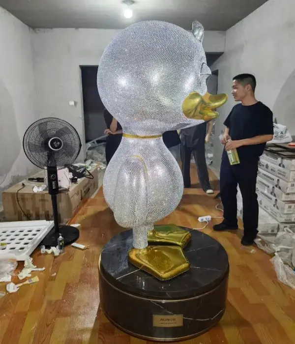 Manual rhinestone application on custom fiberglass sculpture for commercial display